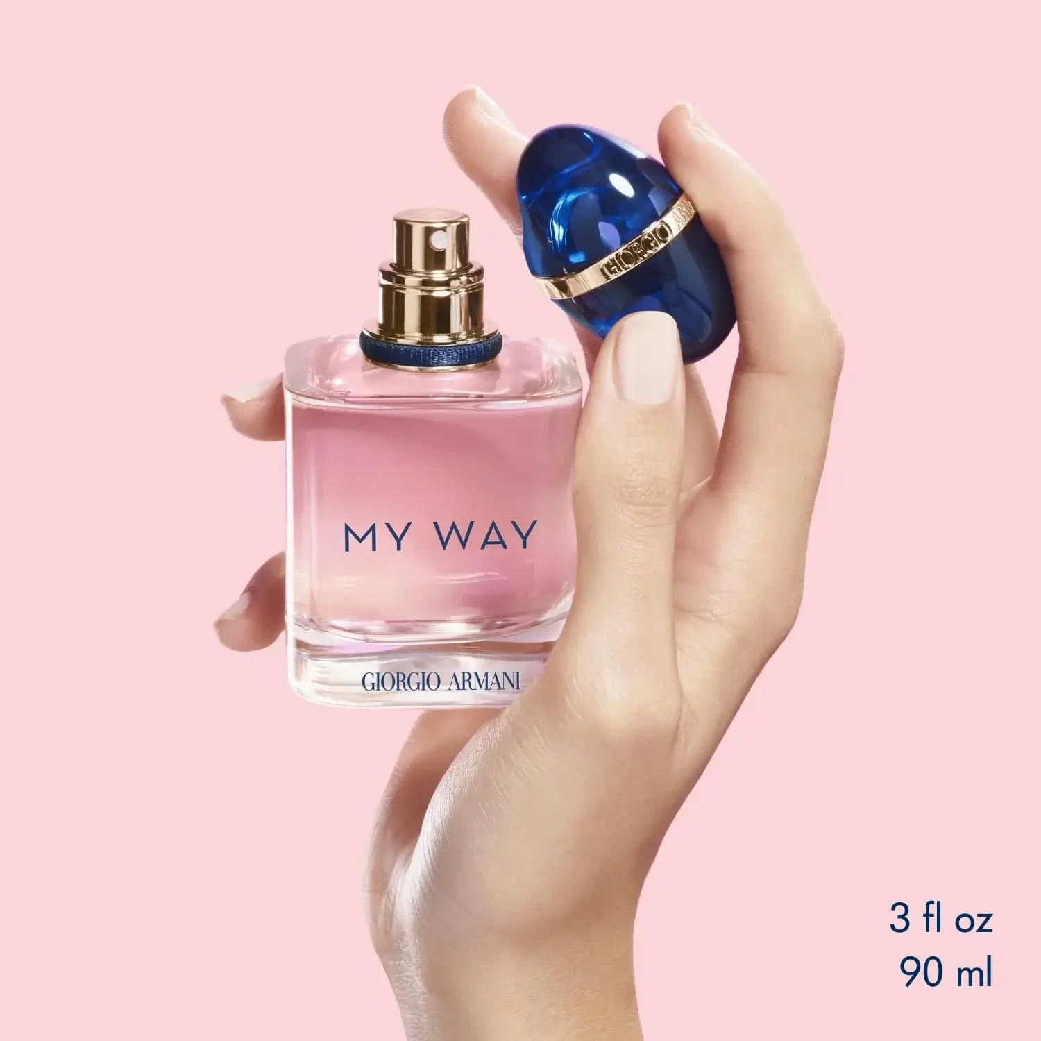 Hand_holding_a_pink_My_Way_Giorgio_Armani_perfume_bottle_against_a_pink_background