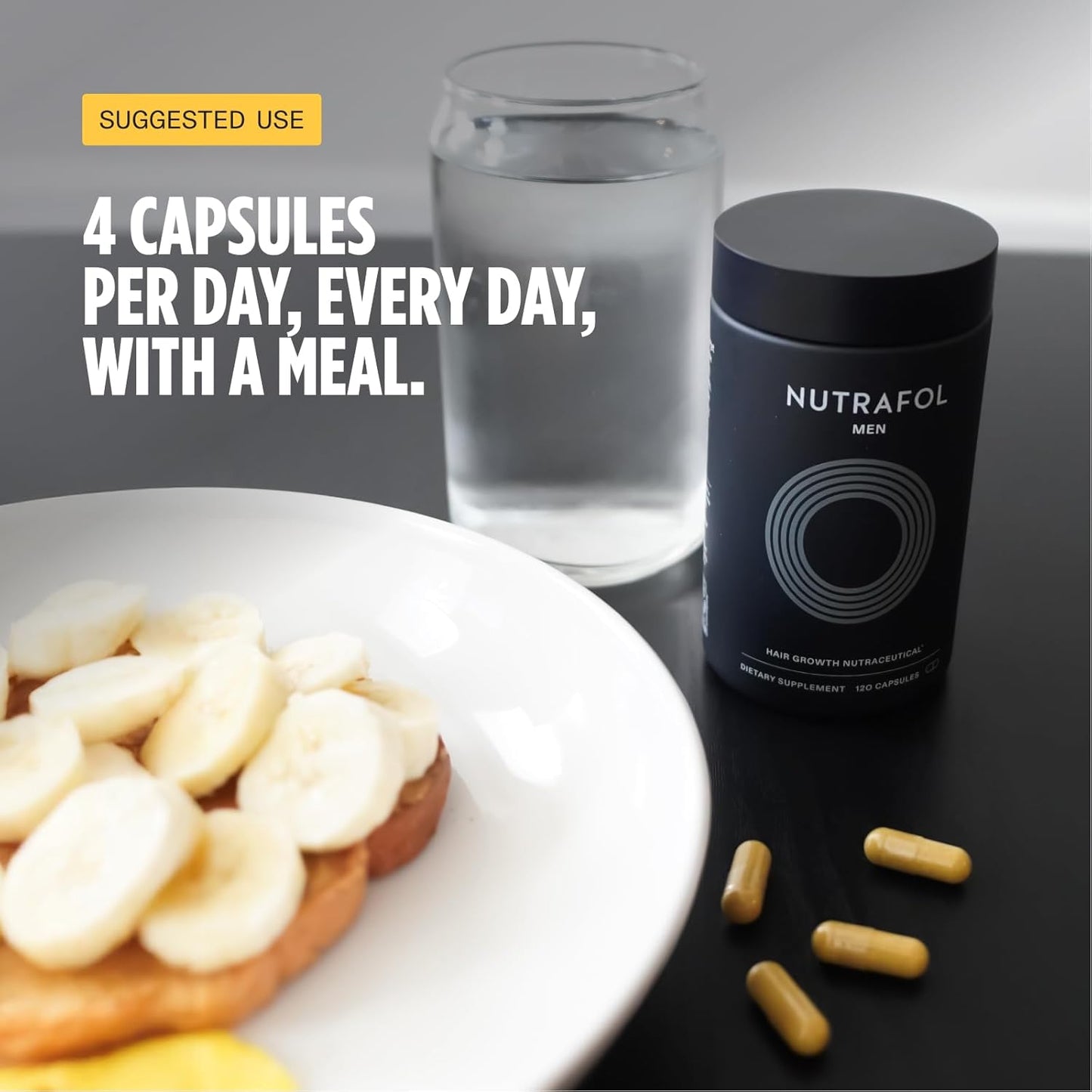 Nutrafol supplement bottle with capsules and a glass of water on a table.