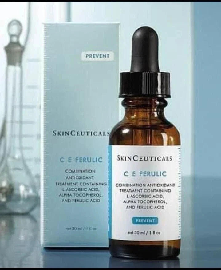 SkinCeuticals C E Ferulic skincare serum bottle with dropper and packaging on a reflective surface.