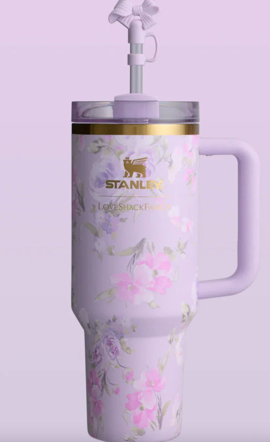 Stainless steel tumbler with floral design and Stanley logo on a light purple background