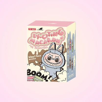 Box of 'Exciting Macaron' vinyl face figures with a cartoon character on a pink background
