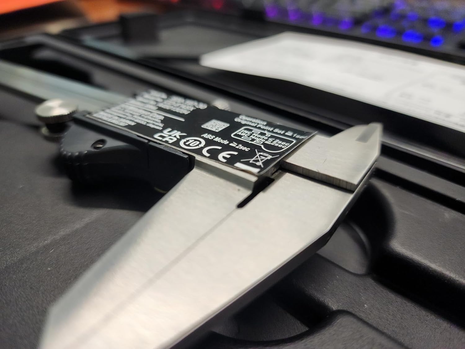 Close-up of a laptop battery with branding and specifications on a blurred background