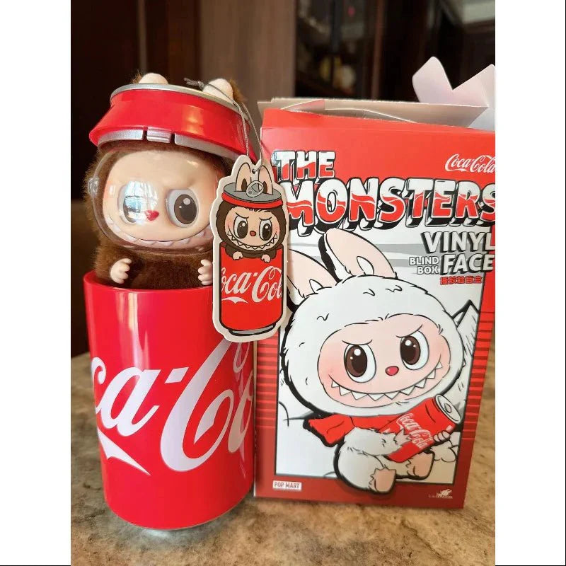 Coca-Cola themed vinyl figure and packaging on a countertop
