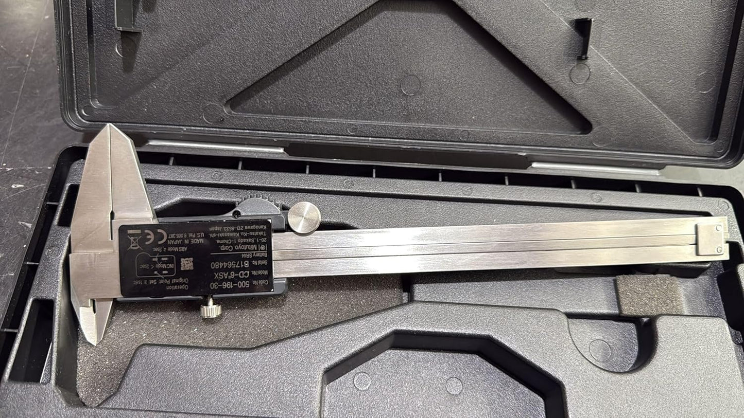 Digital caliper in an open black case on a dark surface
