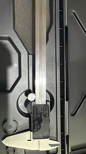 Digital caliper on a metallic surface with a close-up view