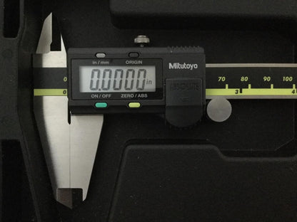Digital caliper with Mitutoyo branding on a dark background