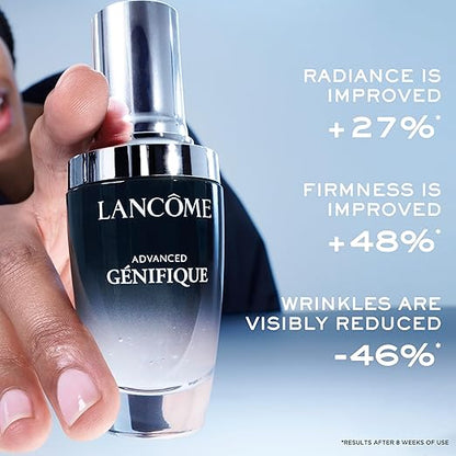 Lancème Advanced Génifique serum bottle held by a hand with product benefits text on a light blue background.