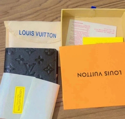 Louis Vuitton wallet and packaging on a wooden surface