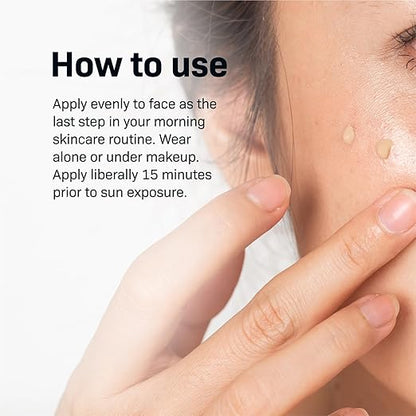 Woman applying Revision Intellishade Original SPF 45 tinted moisturizer to her face