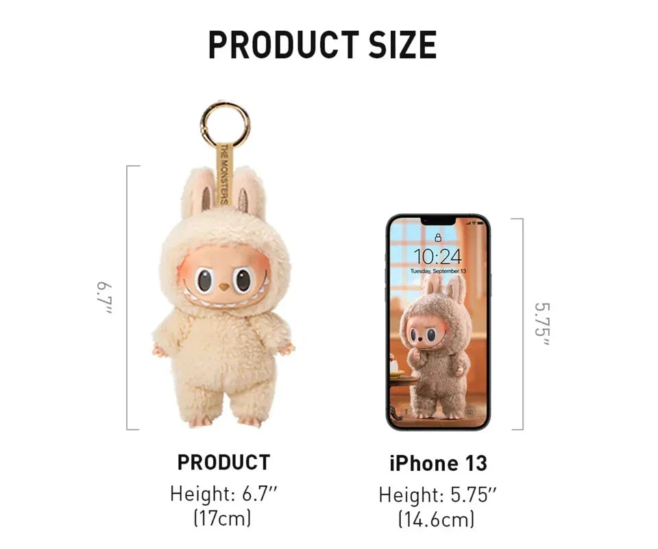 Plush keychain in a bunny costume next to an iPhone 13 for size comparison on a white background.