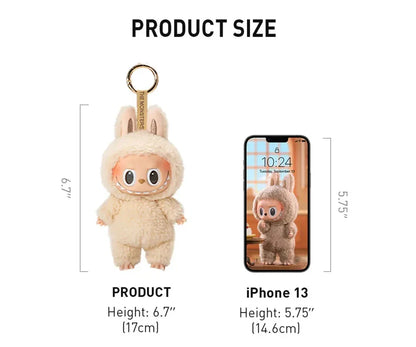 Plush keychain in a bunny costume next to an iPhone 13 for size comparison on a white background.