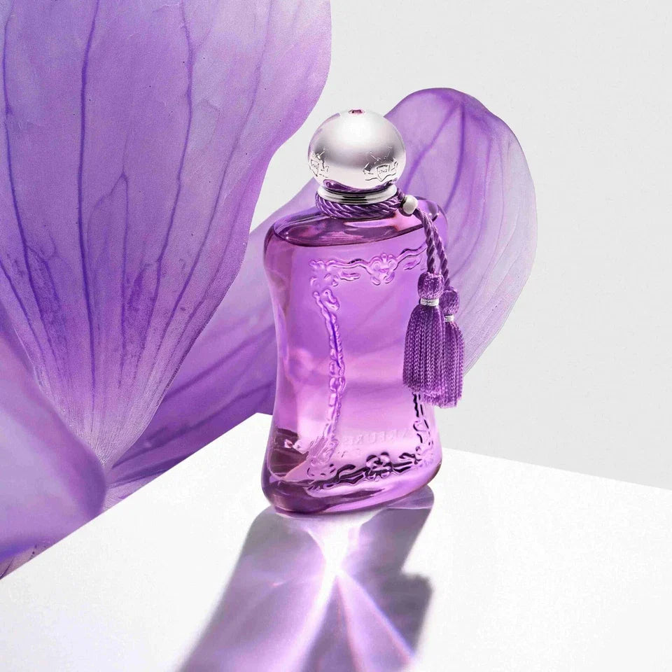Purple perfume bottle with a tassel on a white background