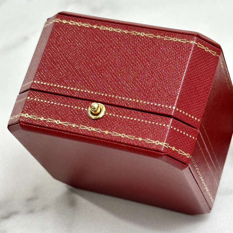 Red jewelry box with gold accents on a white background