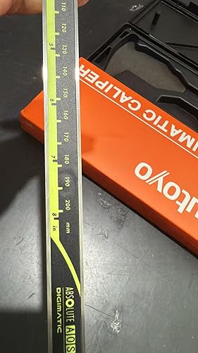 Ruler with measurement scale on a metallic surface