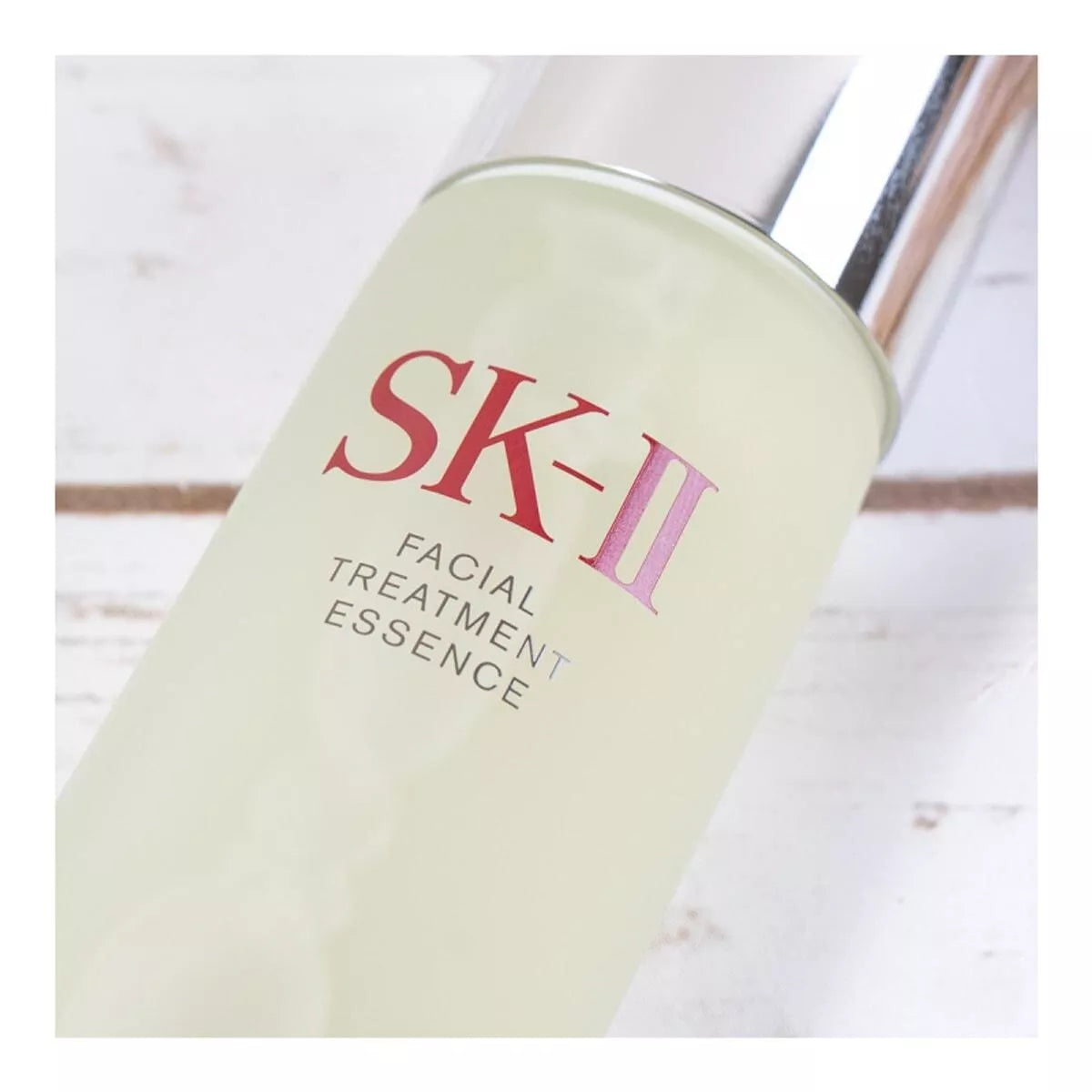 SK-II Facial Treatment Essence bottle on a light wooden surface