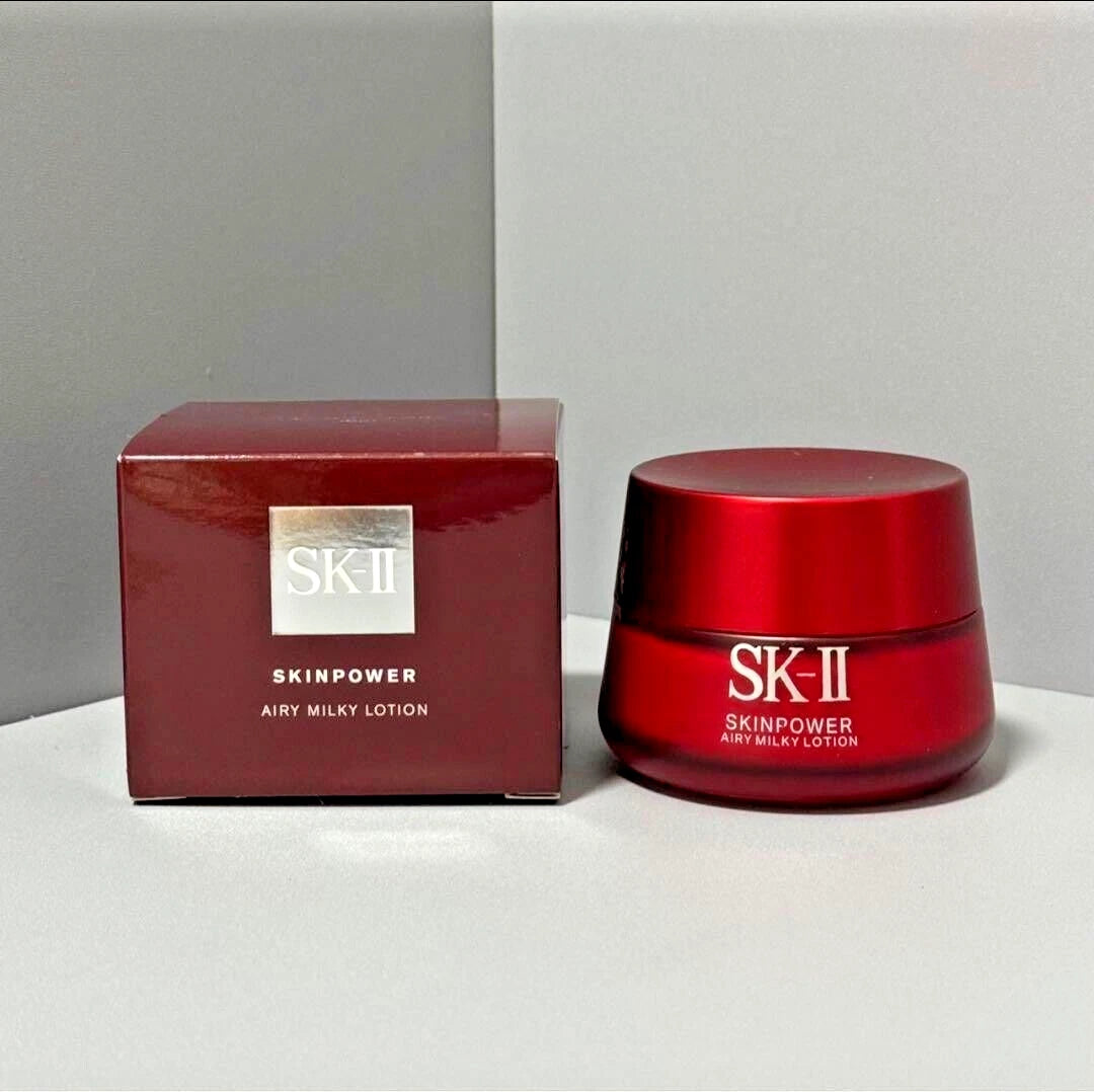 SK-II Skinpower Airy Milky Lotion jar and box on a gray background