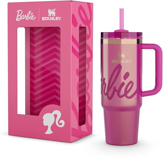 Pink Stanley tumbler with handle and straw next to its packaging, featuring Barbie branding.