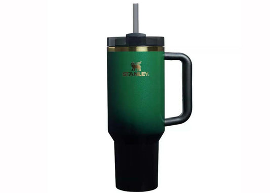 Green Stanley mug with handle and straw on a white background