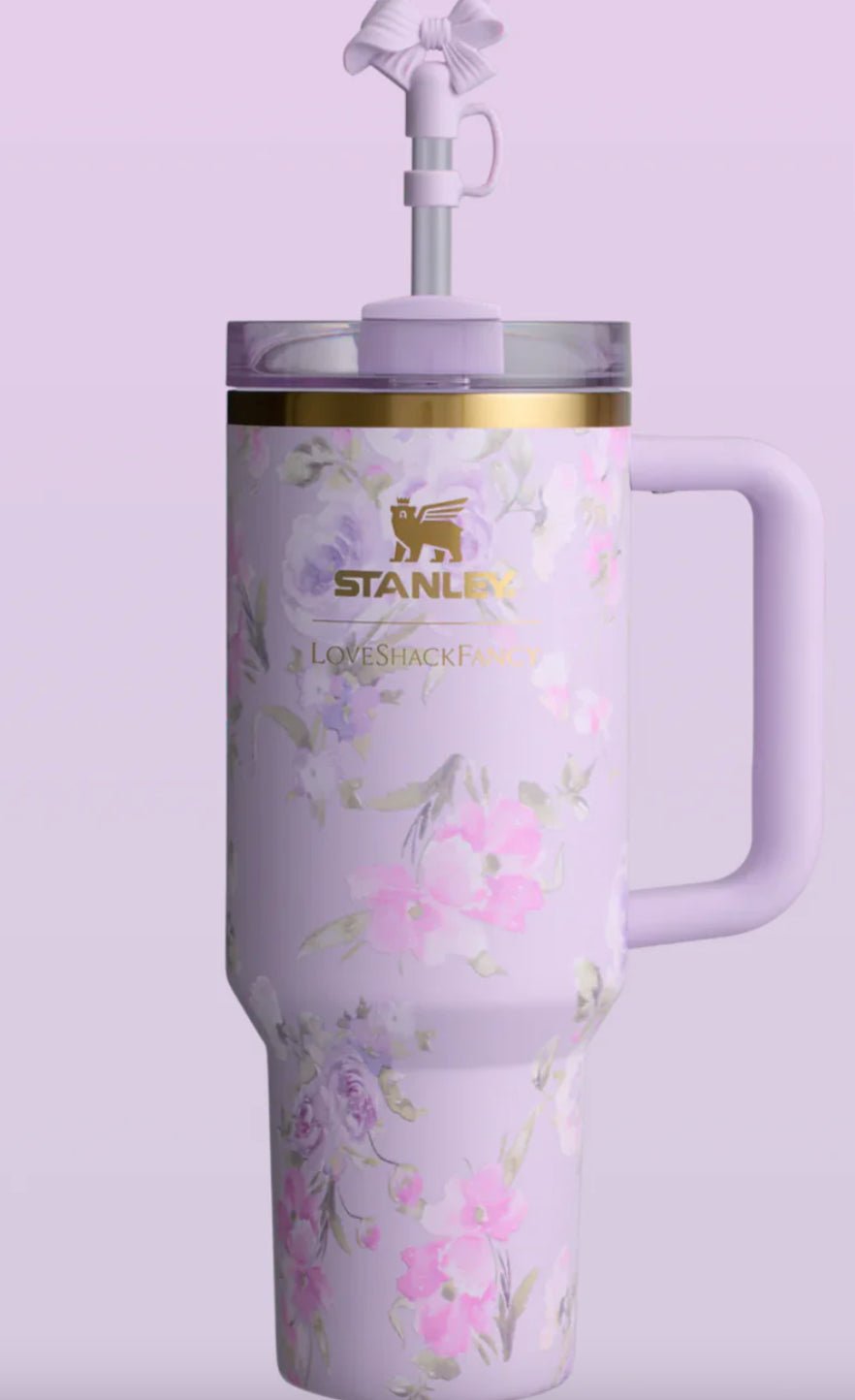 Stainless steel tumbler with floral design and Stanley logo on a light purple background