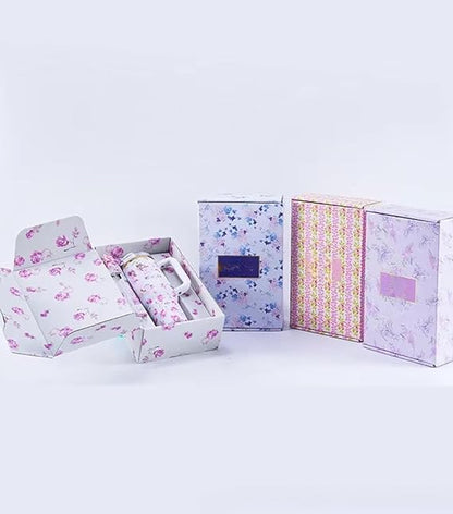 Set of floral-patterned boxes on a light gray background