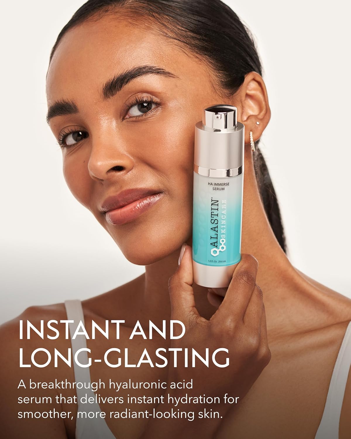 Woman holding Alastin HA Immerse Serum close to face